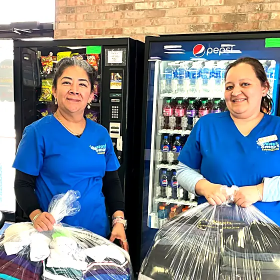 Two Drop & Dash team members with packed orders